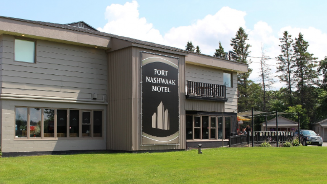 for nashwaak motel buidling and logo, green grass and blue sky