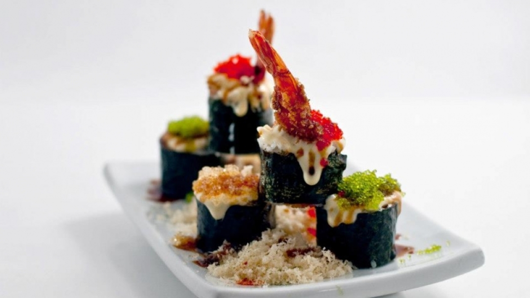 sushi stacked on a white plate