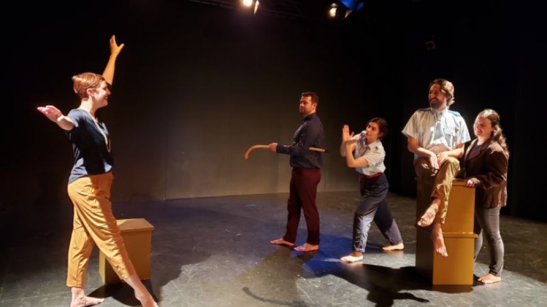 Five people on stage acting