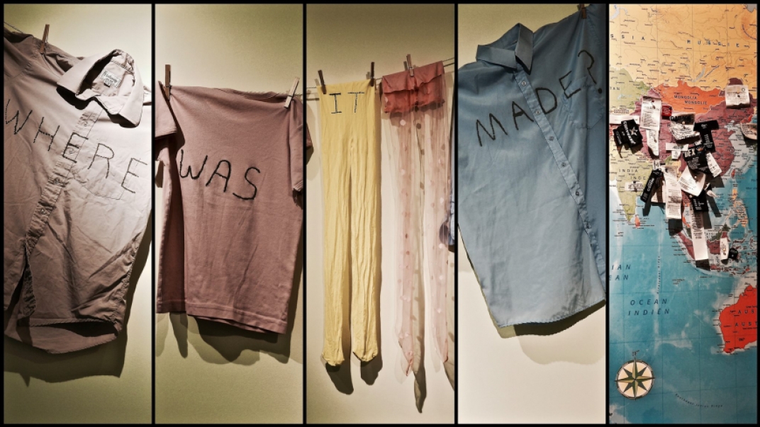 clothing hanging on a clothes line with the words "where was it made" written across them and a map with pins showing where clothes are made