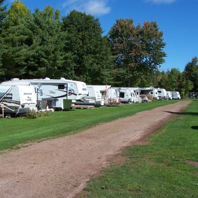 row of RVs parked along a dirt path