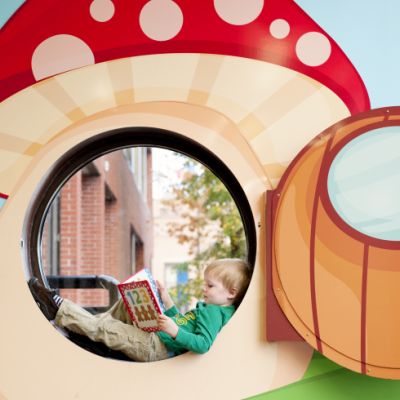 Child reading inside mushroom cutout