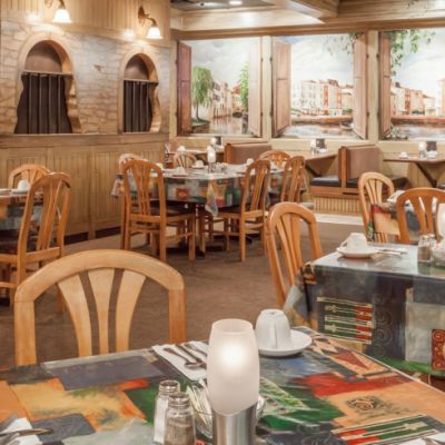 restaurant interior with wooden chairs and brick walls