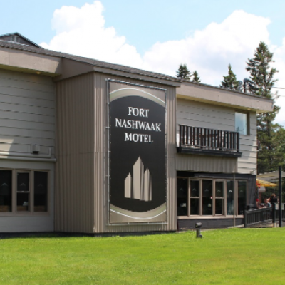 for nashwaak motel buidling and logo, green grass and blue sky