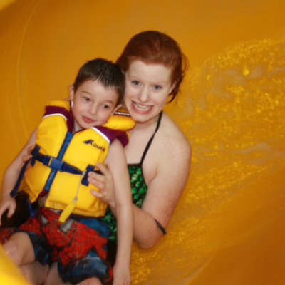 Woman and child going down waterslide