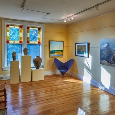 Gallery interior with paintings, pictures, and sculptures on display
