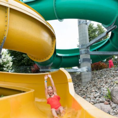 Girl going down yellow water slide