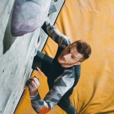 A man doing indoor rock climbing 