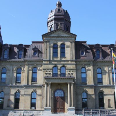 Exterior of legislative assembly building. The building is fashioned in Victorian architecture.