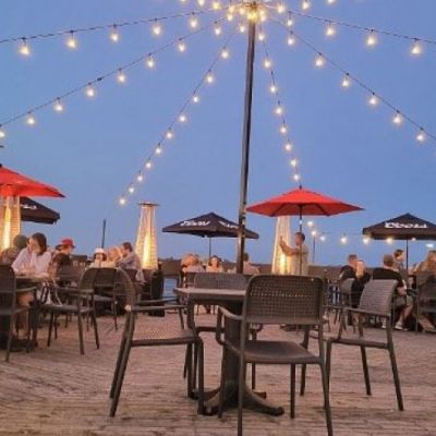 outdoor patio with string lights and red umbrellas