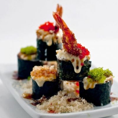 sushi stacked on a white plate