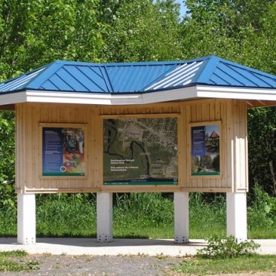 Information booth with park map in middle of park trail