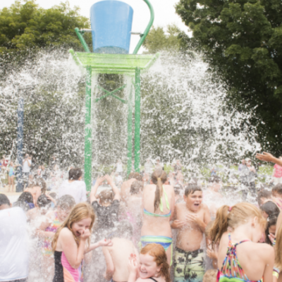 Children at waterpark getting splashed with water