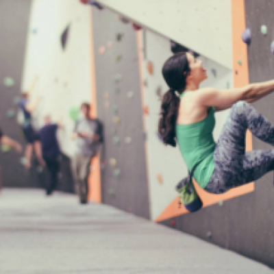 people climbing rock wall