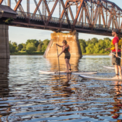 people on paddleboards on river