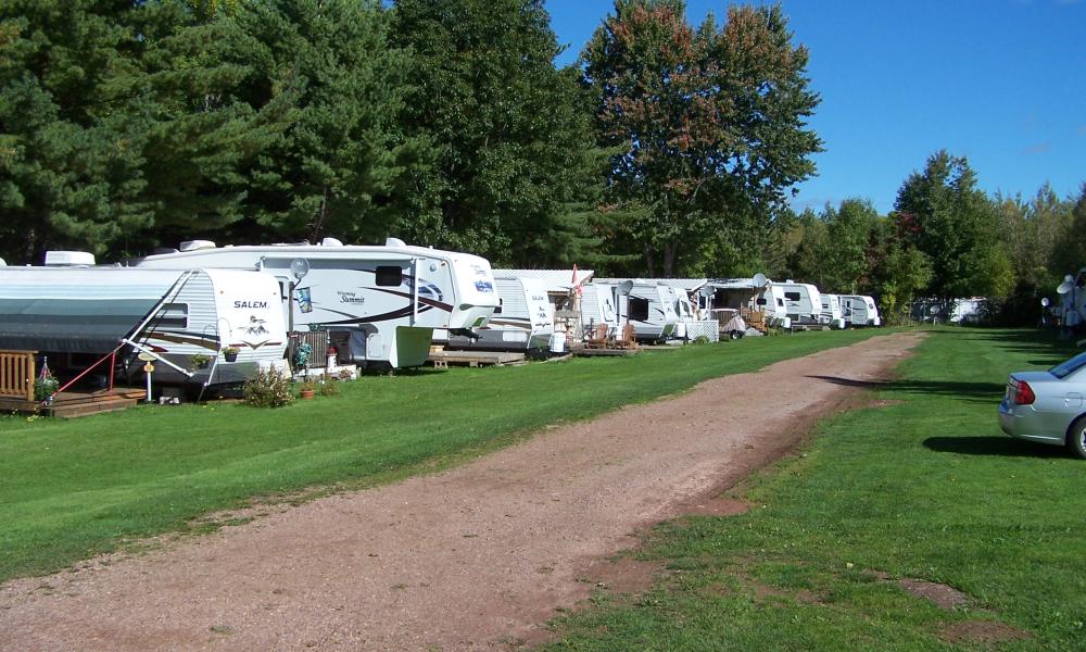 row of RVs parked along a dirt path