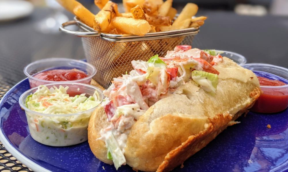lobster roll with fries, coleslaw and a side of ketchup