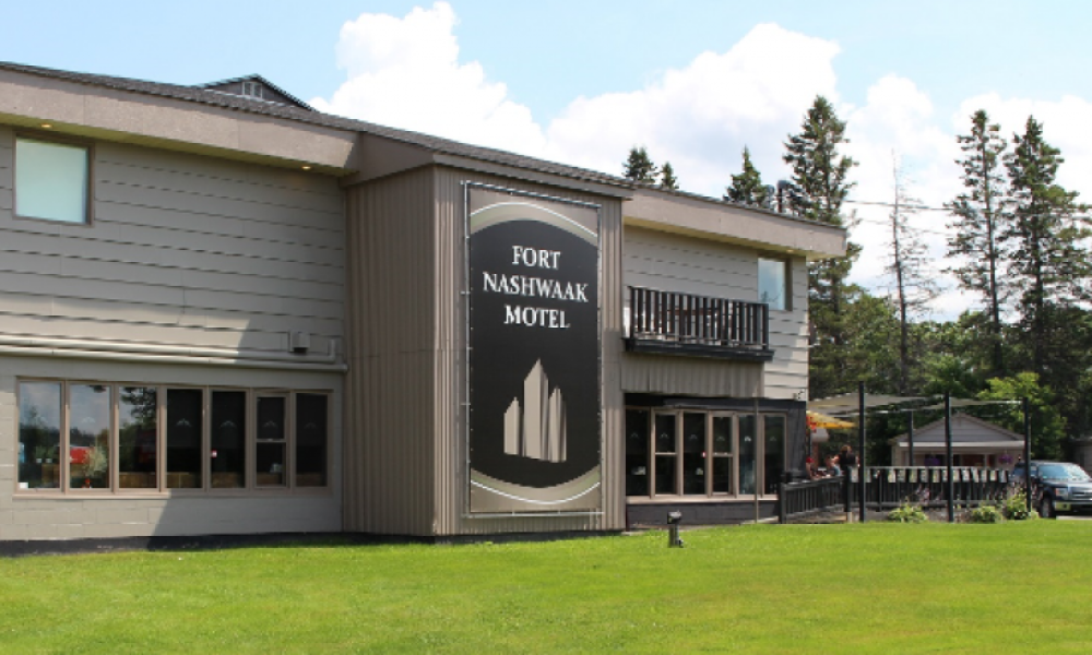 for nashwaak motel buidling and logo, green grass and blue sky