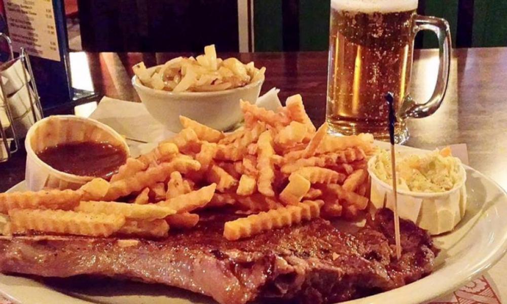steak dinner with gravy, fries and other sides