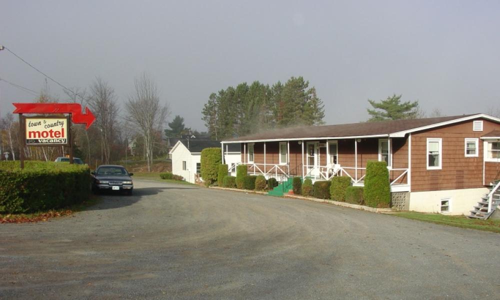 town and country motel with brown siding