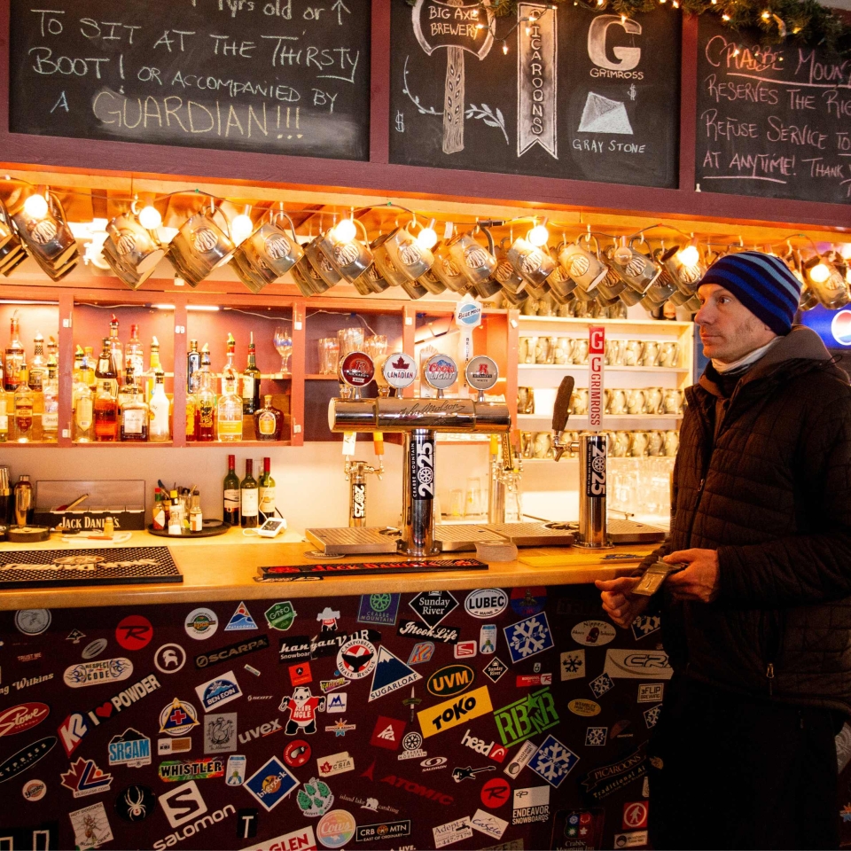 man at bar in Crabbe Mountain Lodge